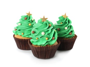 Tasty Christmas tree cupcakes on white background