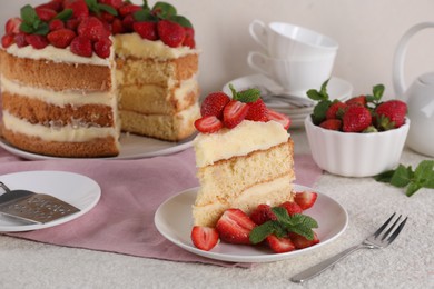 Piece of tasty cake with fresh strawberries and mint on white table