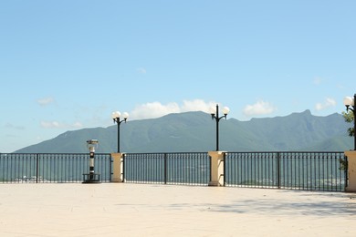 Beautiful mountains from viewpoint with fence and lamps