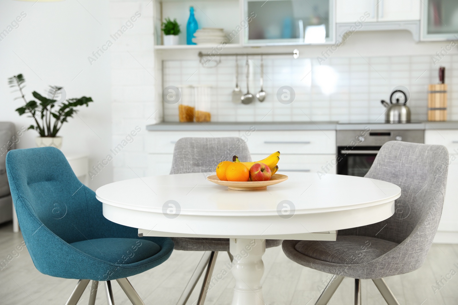 Photo of Stylish room interior with dining table and chairs