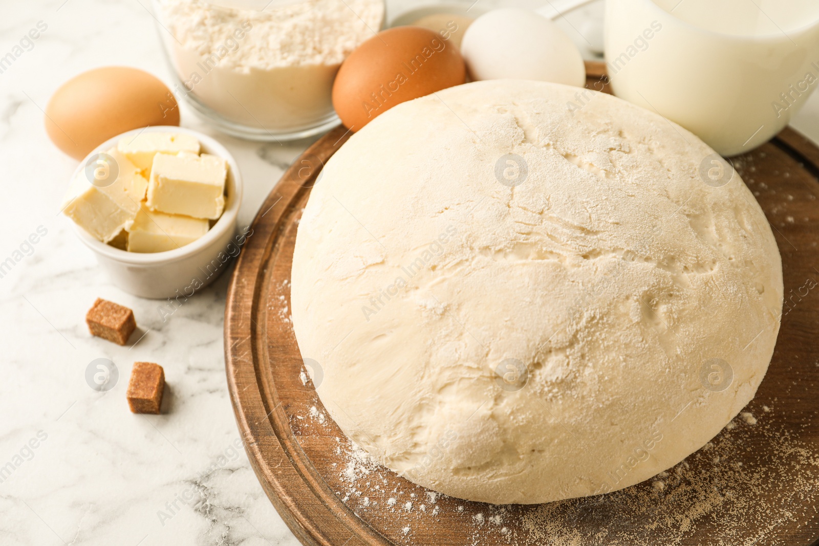 Photo of Fresh dough for pastries on white marble table