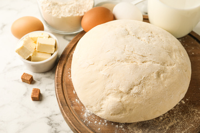 Fresh dough for pastries on white marble table