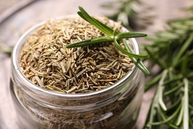 Photo of Jar with dry and fresh rosemary, closeup