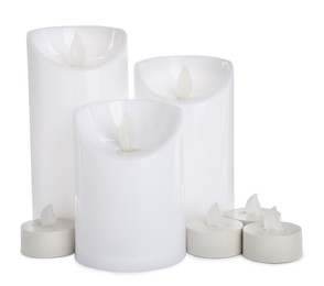 Photo of Different decorative flameless LED candles on white background