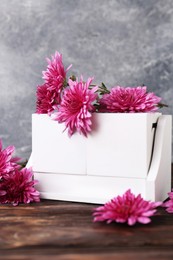 Thanksgiving day, holiday celebrated every fourth Thursday in November. Block calendar and beautiful chrysanthemums on wooden table