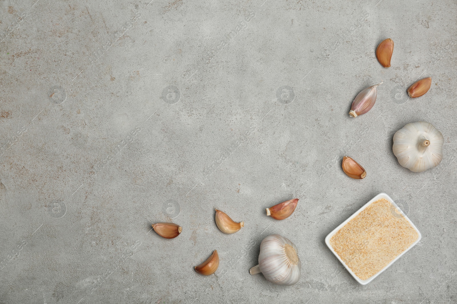 Photo of Flat lay composition with garlic products on grey background