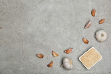 Photo of Flat lay composition with garlic products on grey background