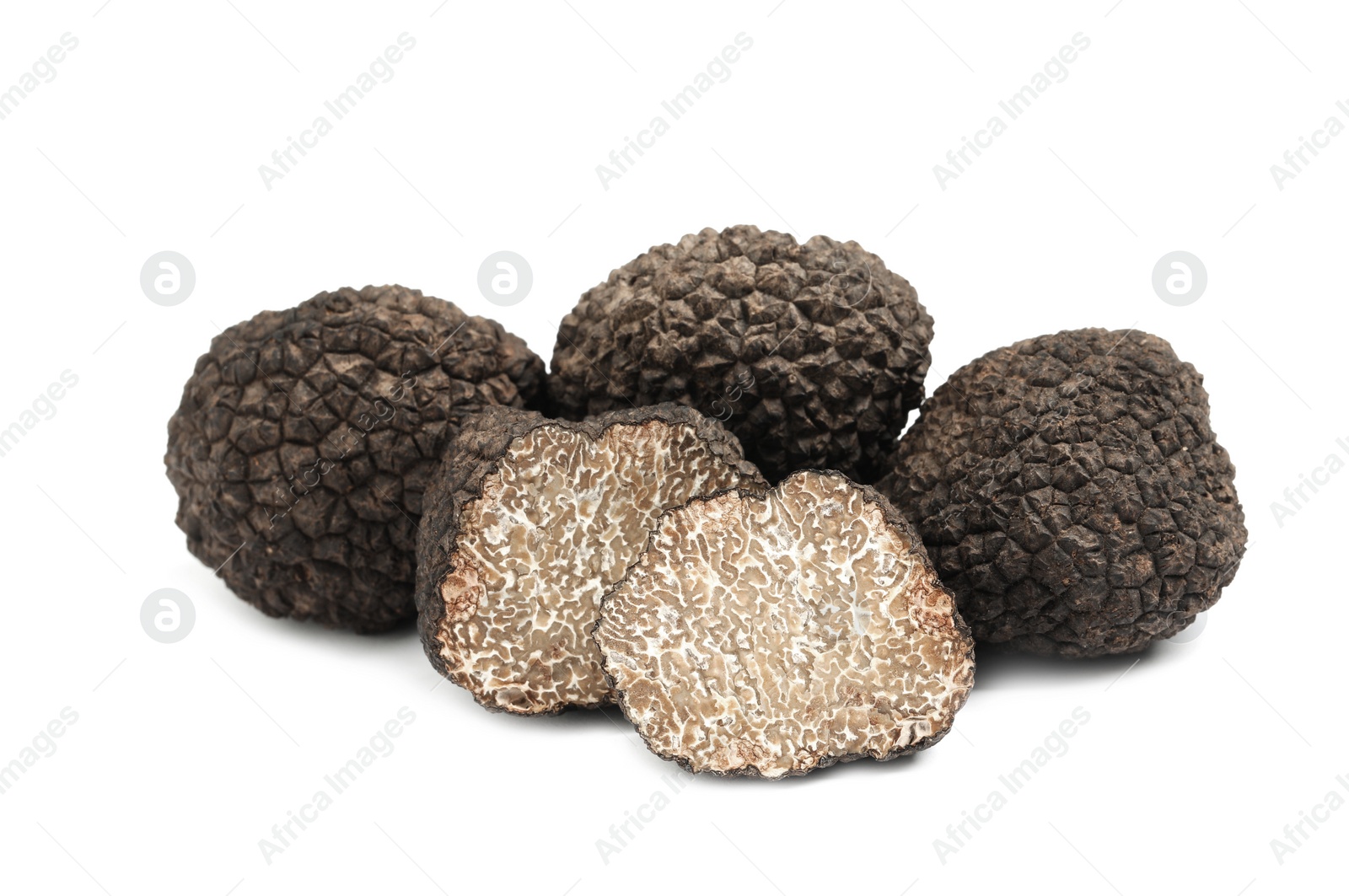 Photo of Cut and whole black truffles isolated on white