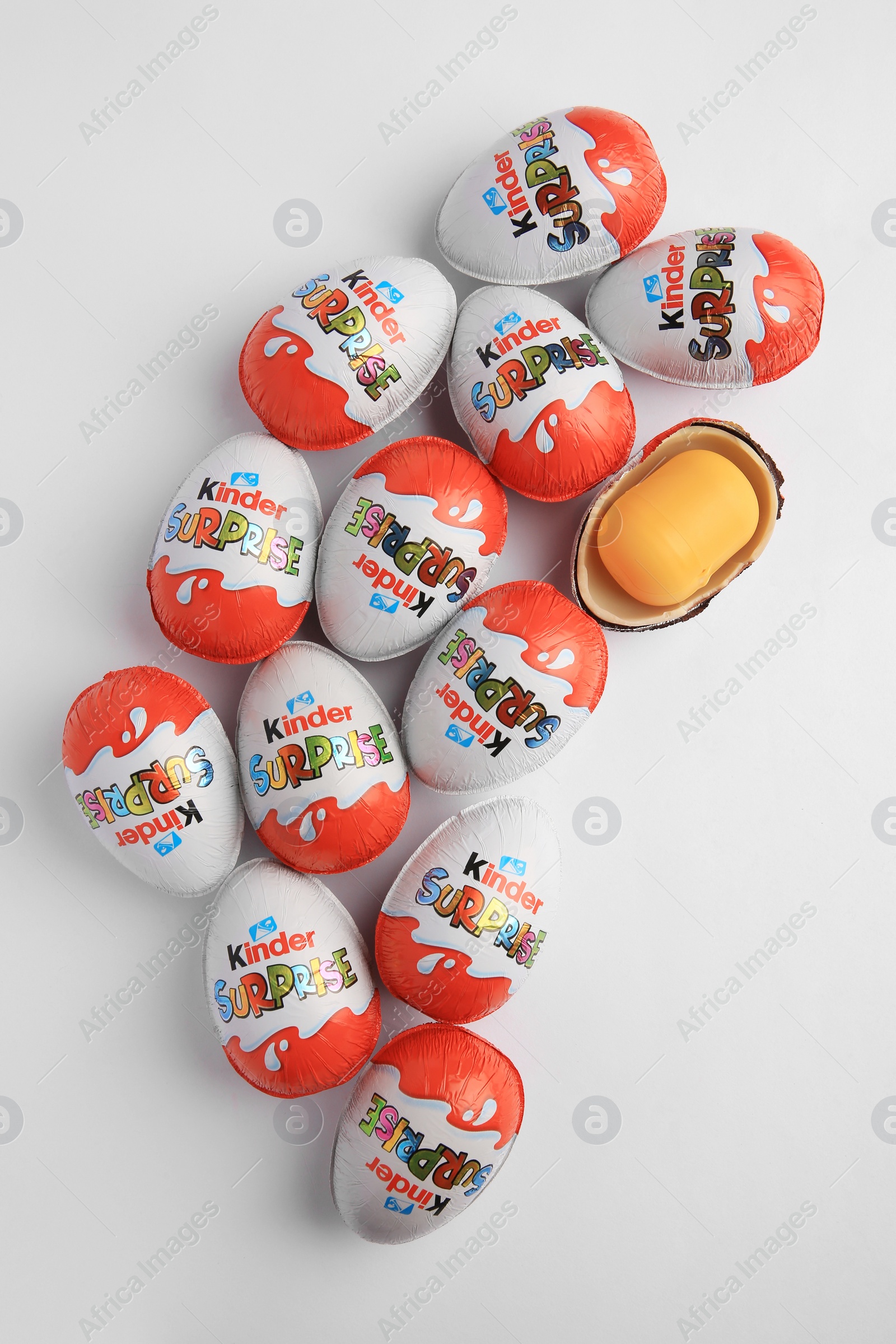 Photo of Sveti Vlas, Bulgaria - June 26, 2023: Kinder Surprise Eggs and plastic capsule with toy on white background, flat lay