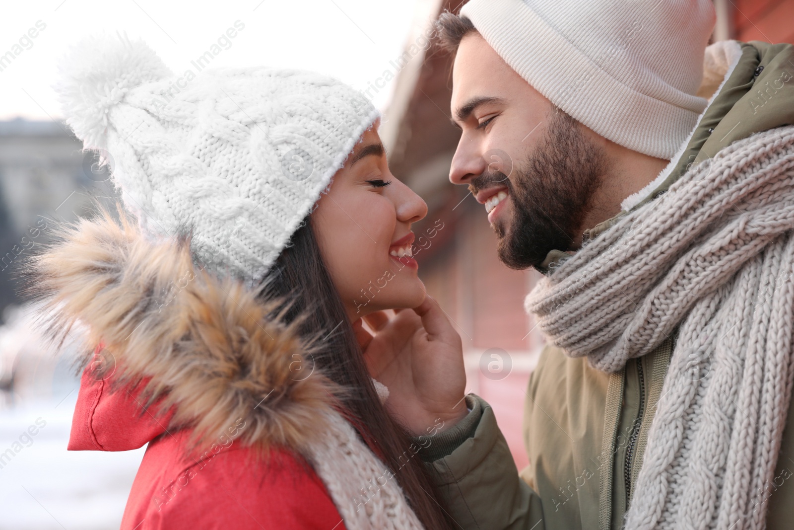 Photo of Happy young couple spending time together at winter fair. Christmas celebration