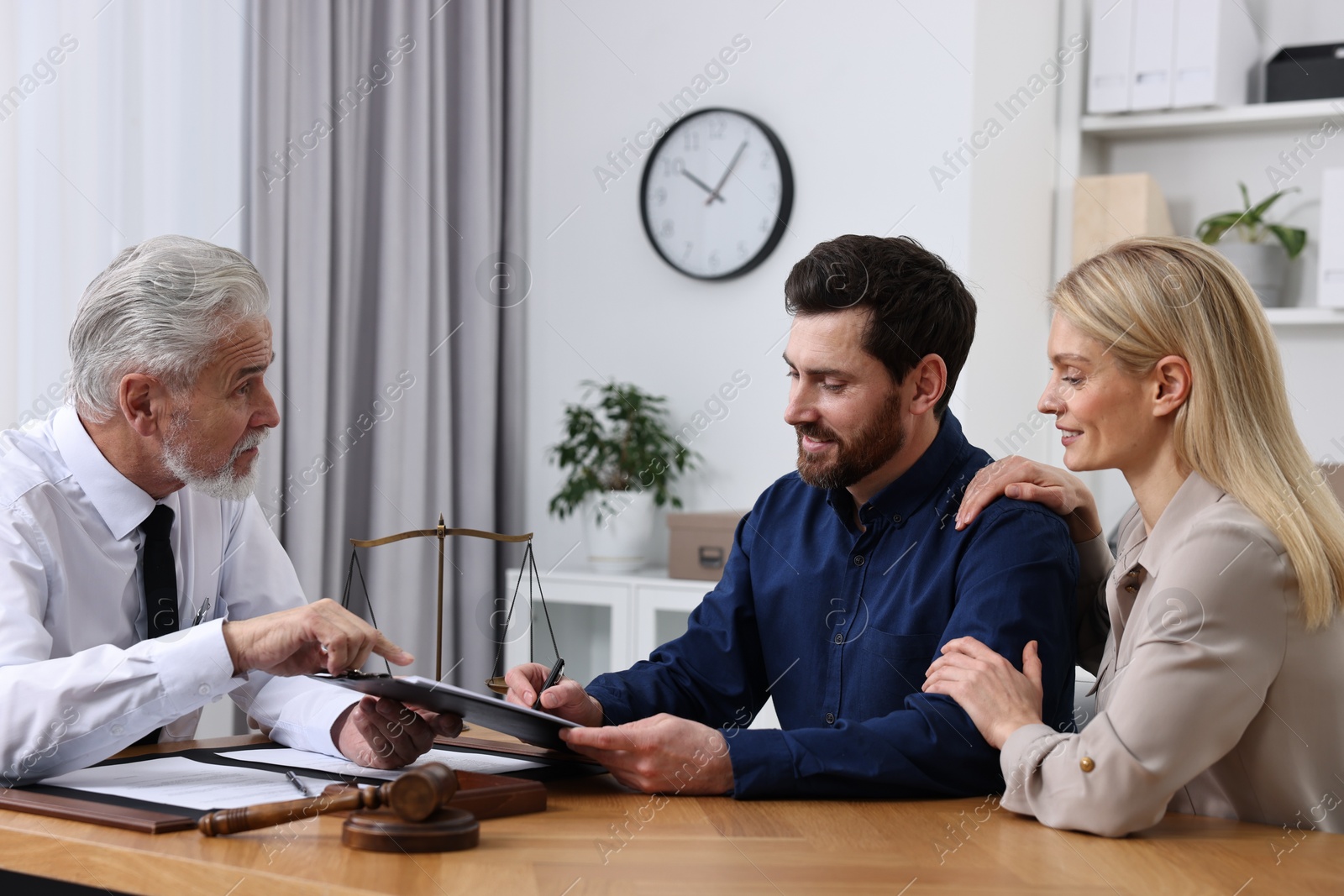 Photo of Couple having meeting with lawyer in office