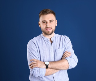 Portrait of handsome happy man on color background