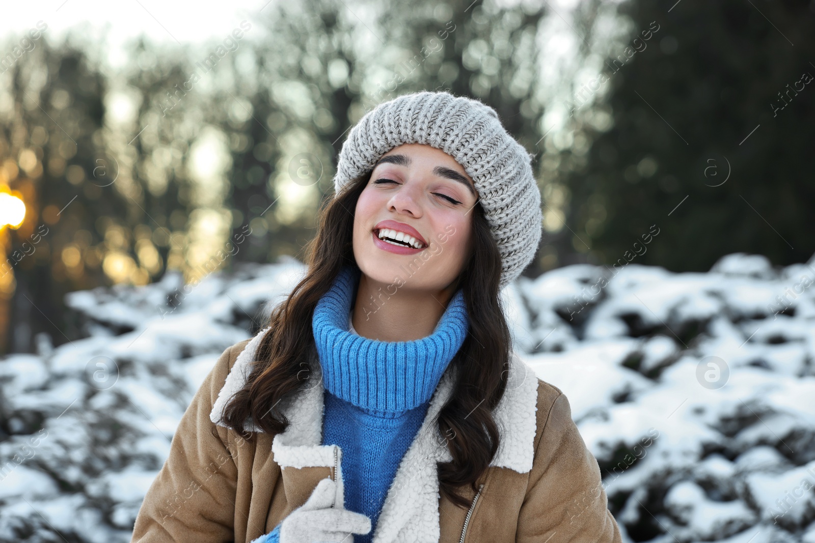 Photo of Portrait of happy woman in snowy park