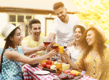 Image of Happy friends with drinks having fun at barbecue party outdoors on sunny day