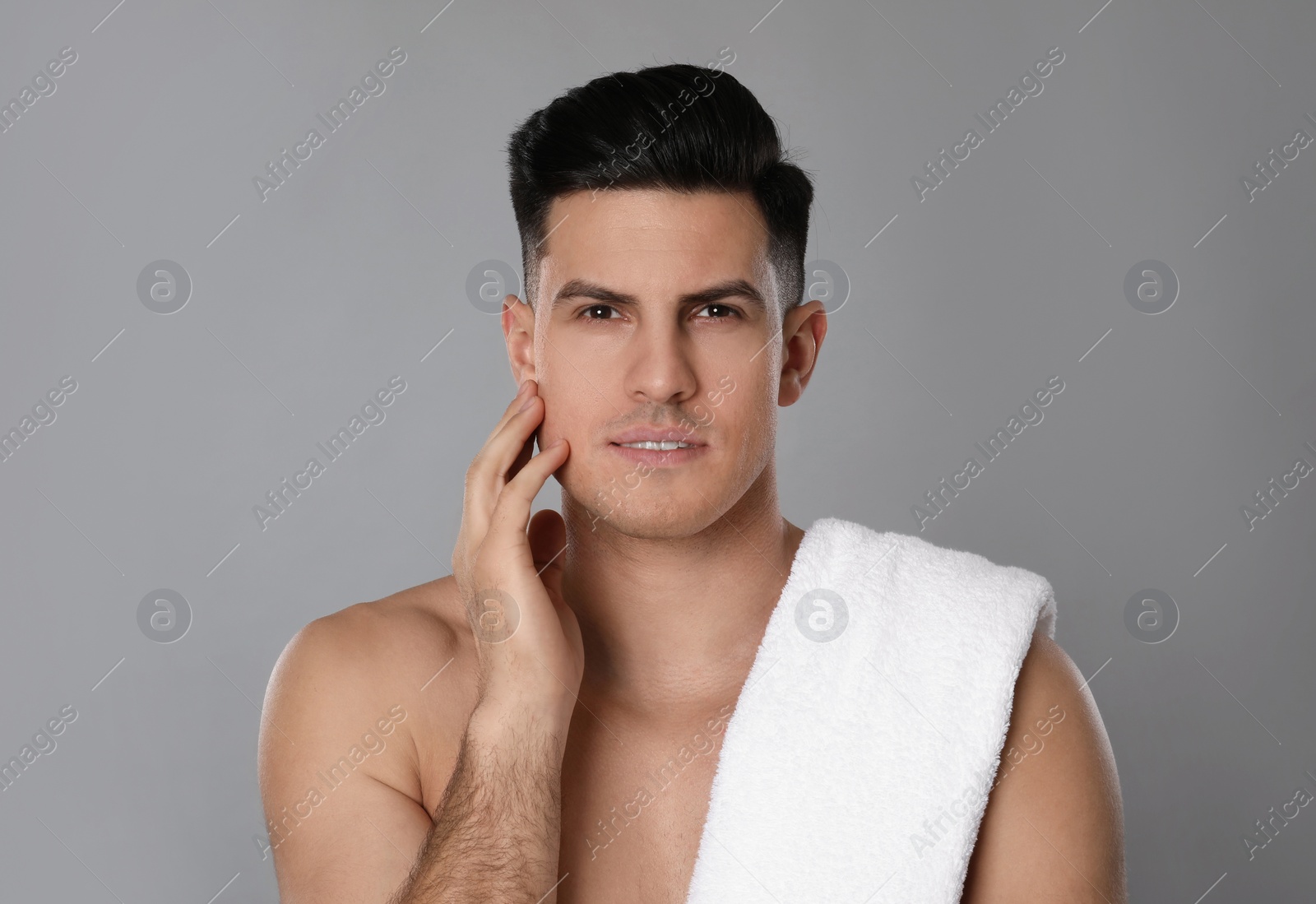 Photo of Handsome man after shaving on grey background