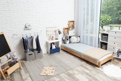 Photo of Montessori bedroom interior with floor bed and toys