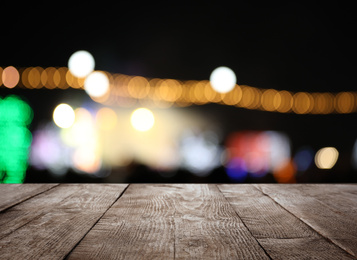 Image of Empty wooden surface against blurred lights. Bokeh effect 