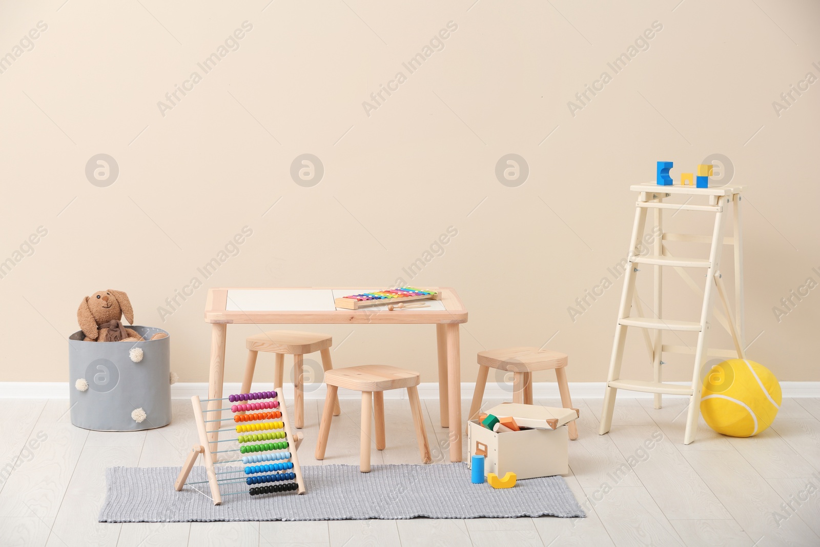 Photo of Stylish child's room interior with toys and new furniture