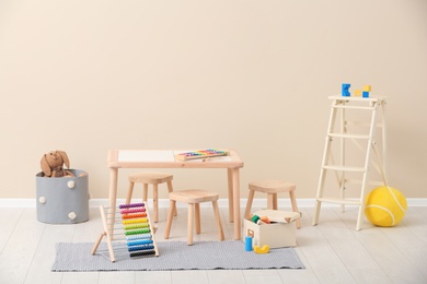 Photo of Stylish child's room interior with toys and new furniture