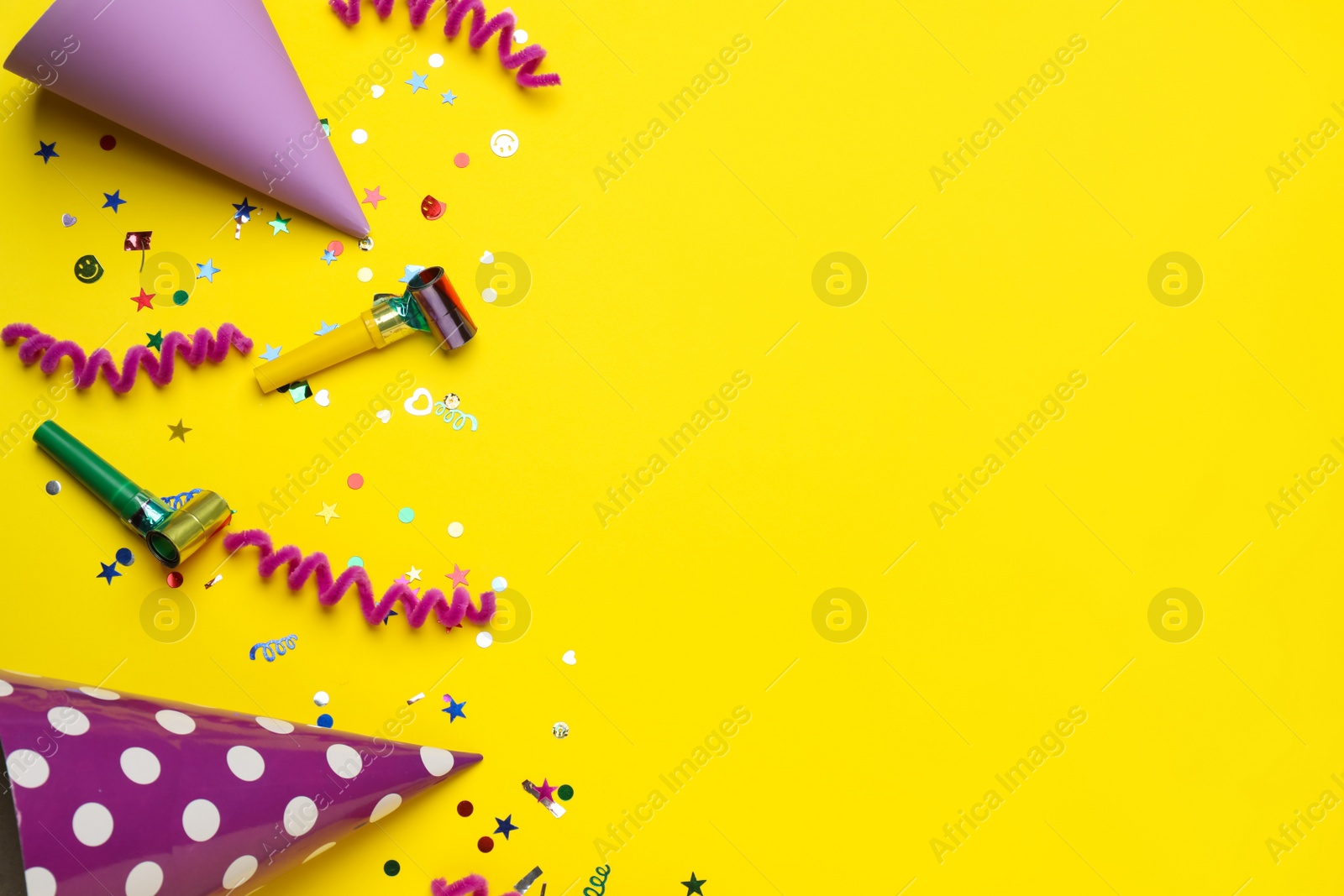 Photo of Flat lay composition with party items on yellow background, space for text