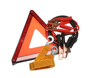 Photo of Emergency warning triangle, towing strap and battery jumper cables on white background, top view. Car safety