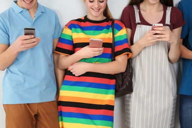 Group of teenagers on light background. Youth lifestyle and friendship