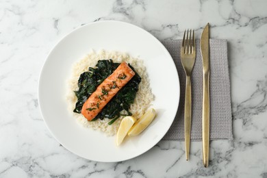 Photo of Tasty salmon with rice and spinach served on white marble table, flat lay
