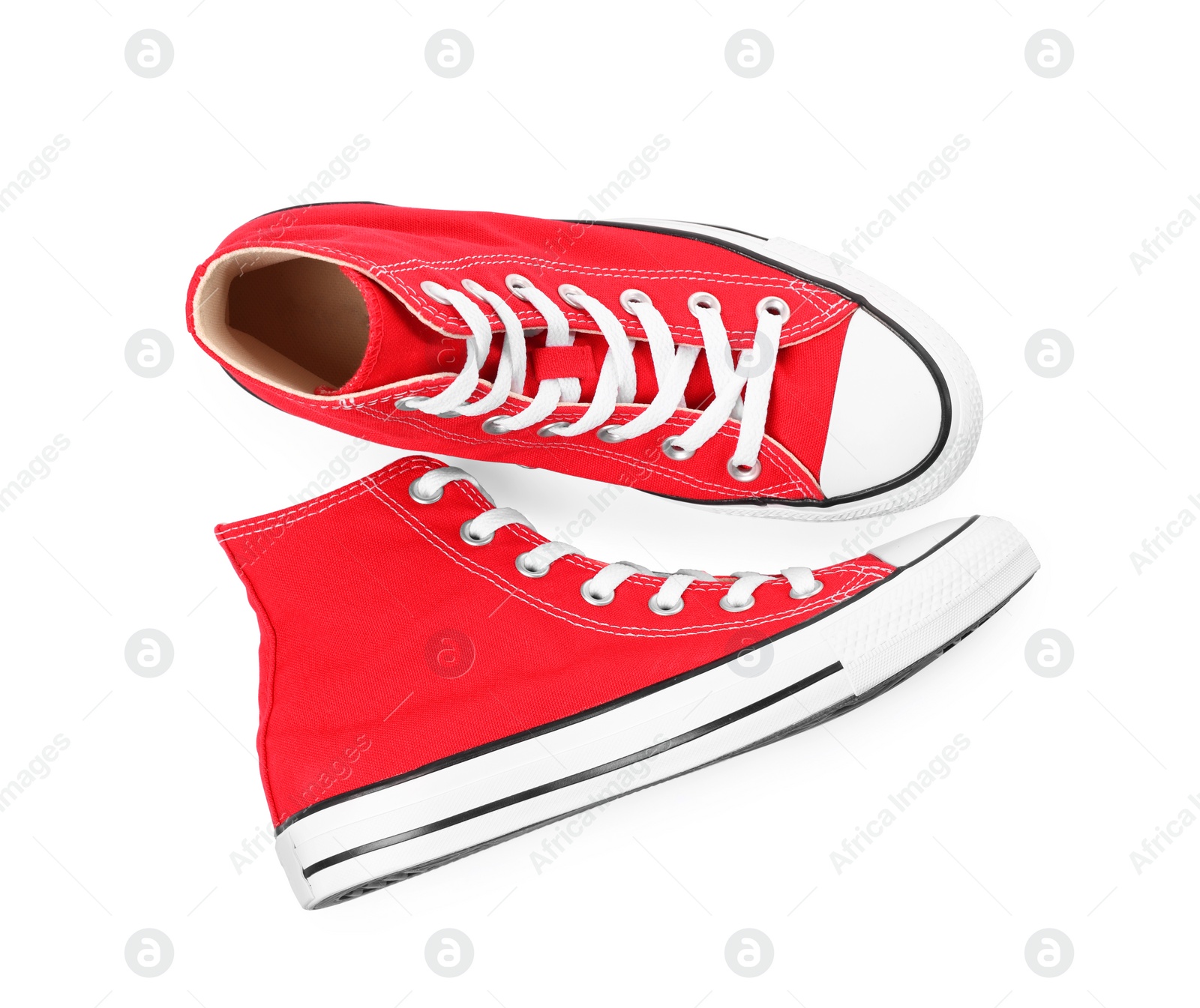 Photo of Pair of new red stylish plimsolls on white background, top view