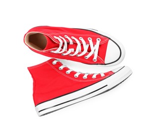 Pair of new red stylish plimsolls on white background, top view