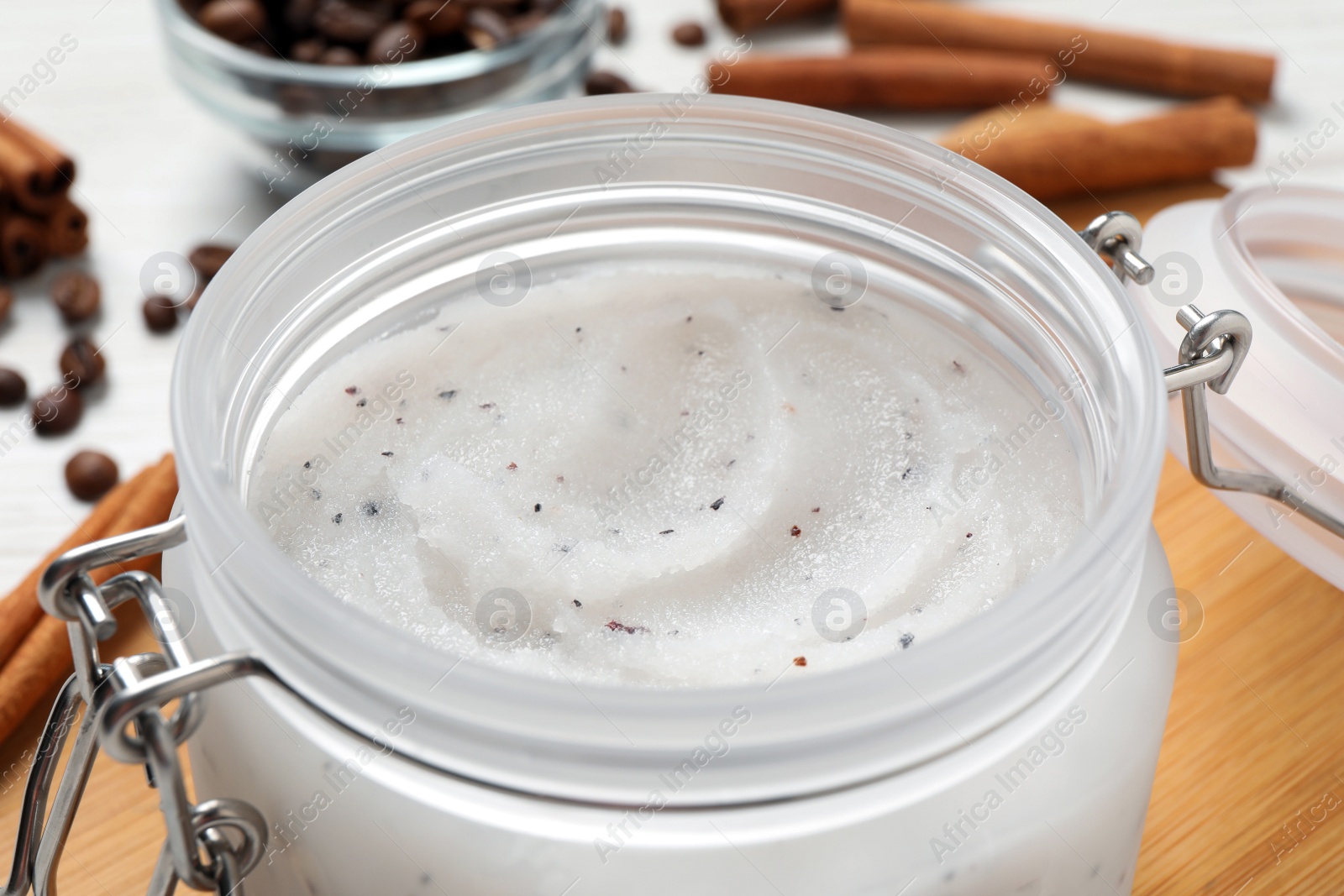 Photo of Body scrub in glass jar on table, closeup