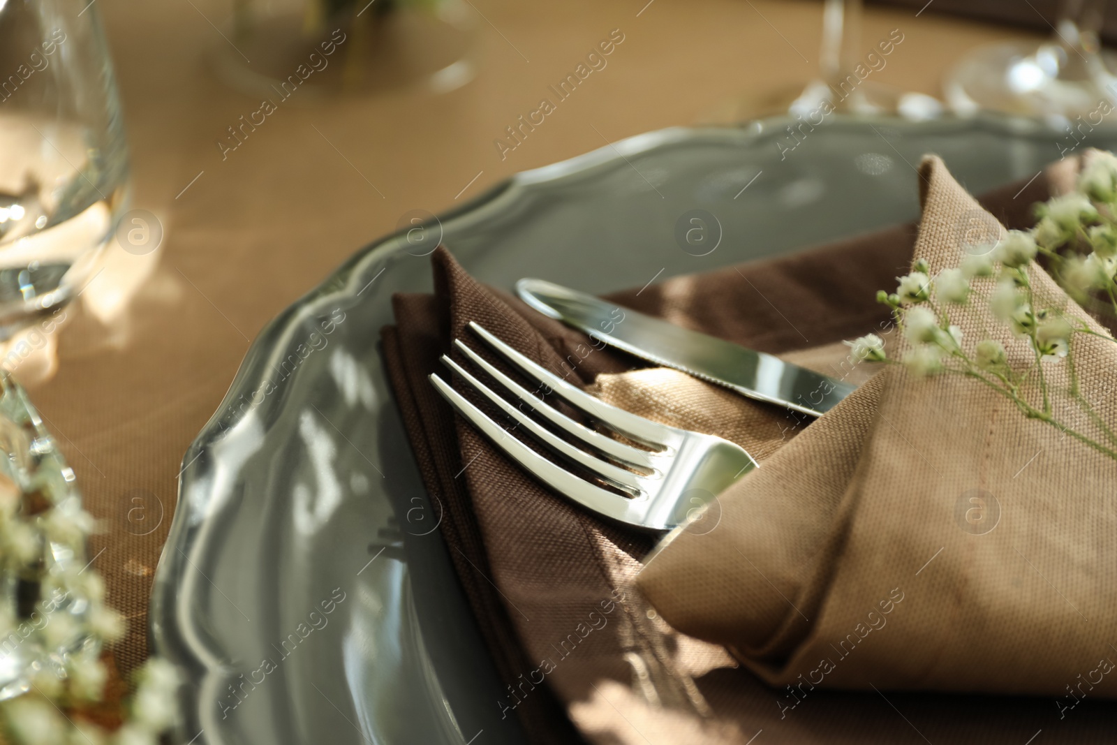 Photo of Festive table setting with beautiful tableware and floral decor