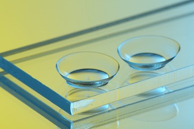 Pair of contact lenses on mirror surface, closeup