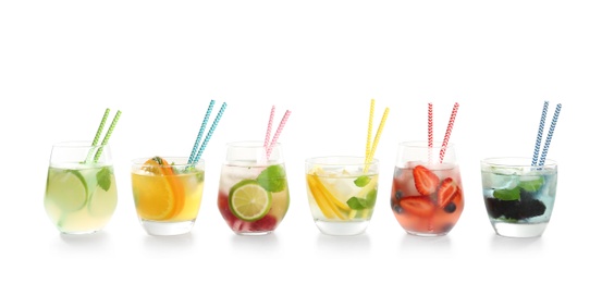 Photo of Glasses with tasty lemonades on white background