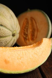 Photo of Slice of tasty fresh melon on wooden table, closeup