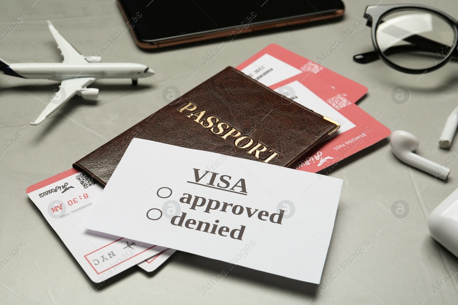 Photo of Passport and tickets on grey table, closeup. Visa receiving