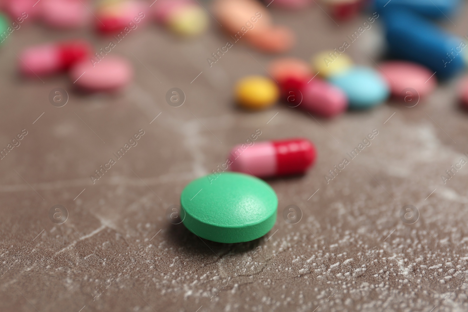 Photo of Different pills on grey background