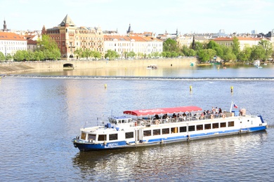 PRAGUE, CZECH REPUBLIC - APRIL 25, 2019: Beautiful cityscape with boats on Vltava river