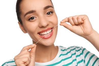 Young woman flossing her teeth on white background. Cosmetic dentistry