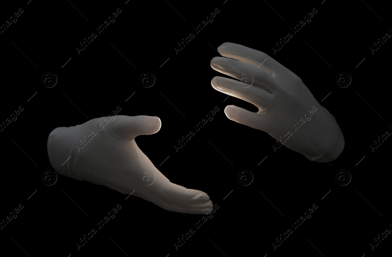 Photo of Magician holding something on black background, closeup