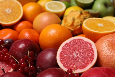 Photo of Different ripe fruits and berries as background, closeup