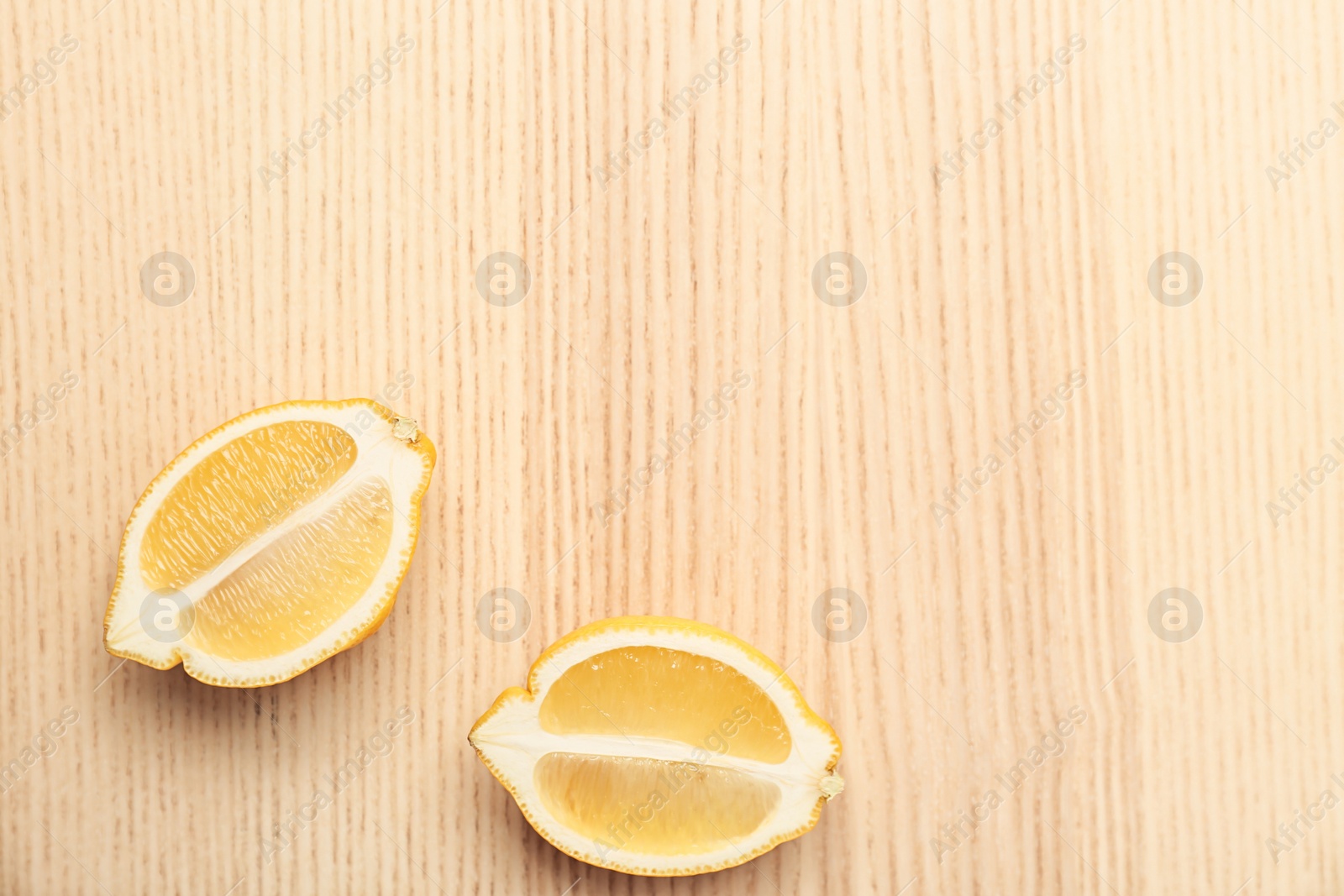 Photo of Lemon pieces on wooden table