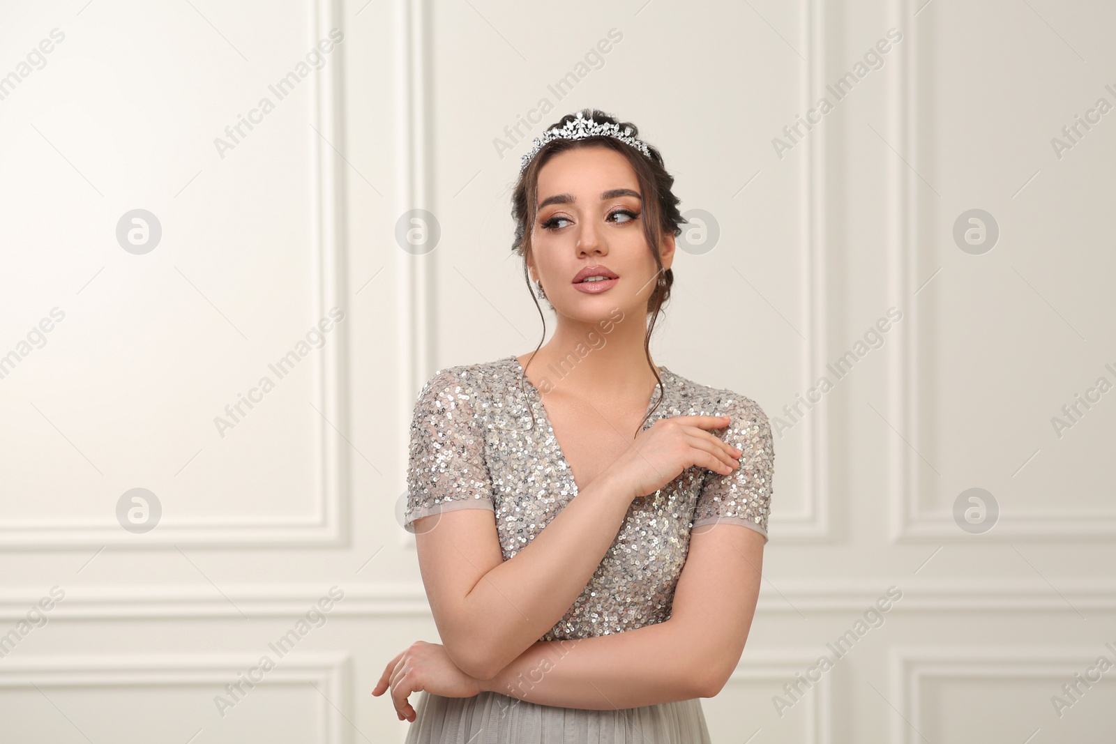 Photo of Beautiful young woman wearing luxurious tiara indoors