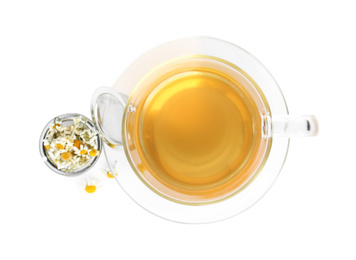 Photo of Fresh chamomile tea and dry flowers in infuser isolated on white, top view