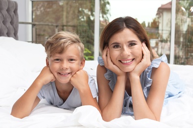 Portrait of mother and son in bedroom