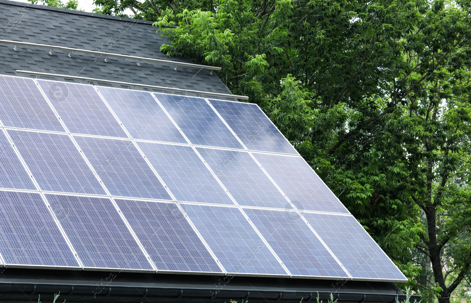 Photo of Building with installed solar panels on roof. Alternative energy source