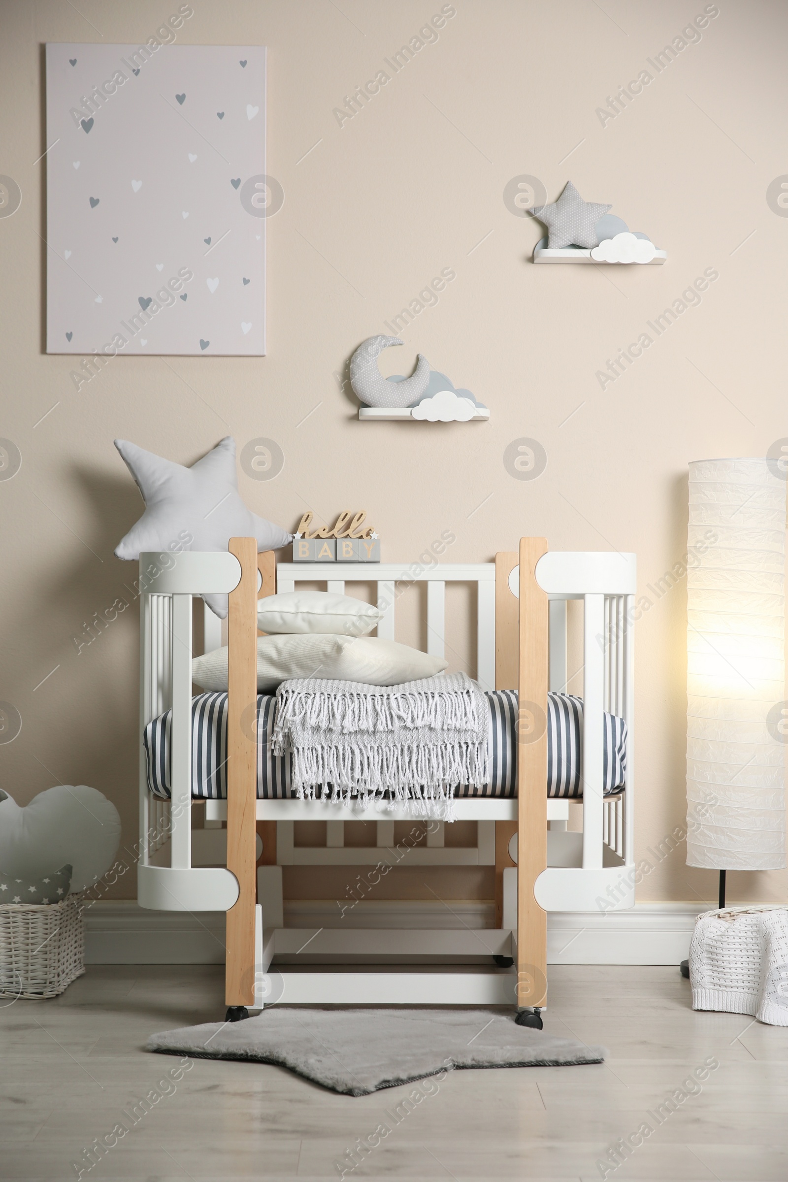 Photo of Cute baby room interior with modern crib and toys