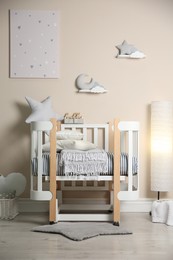 Photo of Cute baby room interior with modern crib and toys