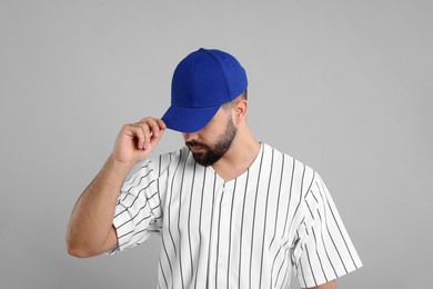 Photo of Man in stylish blue baseball cap on light grey background