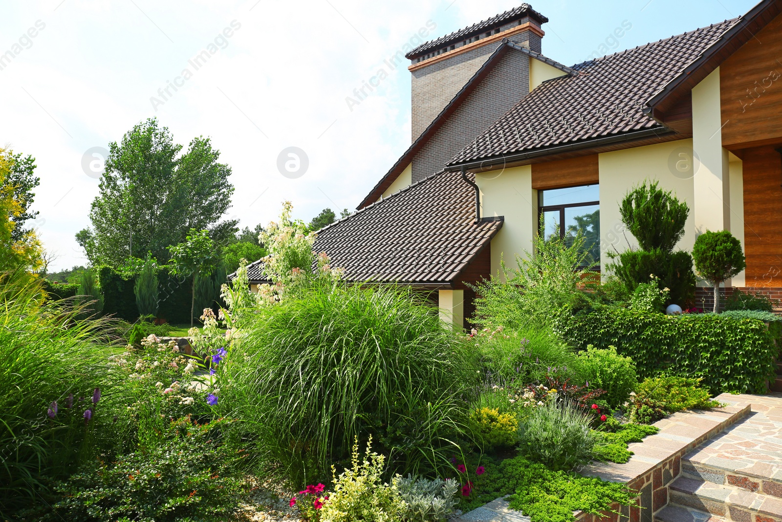 Photo of Landscape with modern house and beautiful garden on sunny day