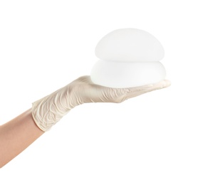 Photo of Doctor holding silicone implants for breast augmentation on white background. Cosmetic surgery